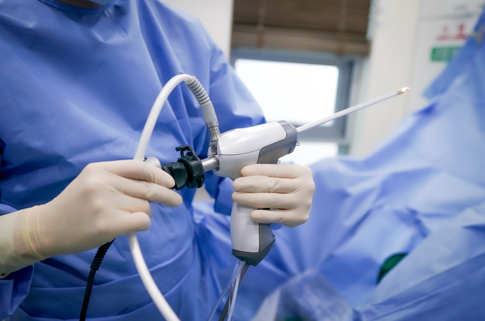 Close-up of a clinician holding an endoscopic instrument