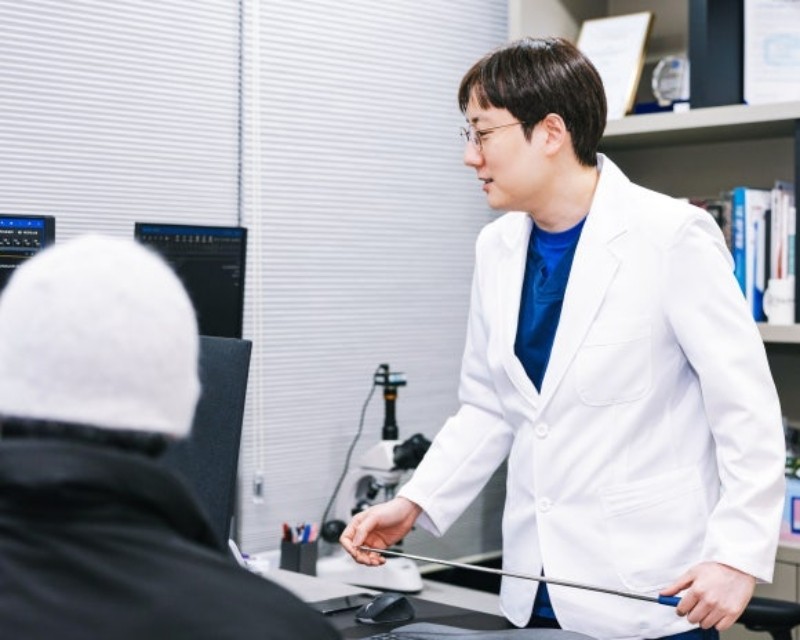 Urologist discussing examination findings with a seated patient