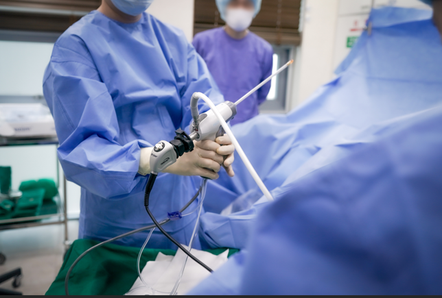 Clinician holding an endoscopic instrument during a procedure