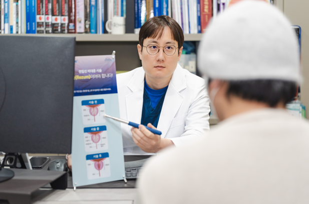 Urologist using a diagram to explain a treatment to a patient