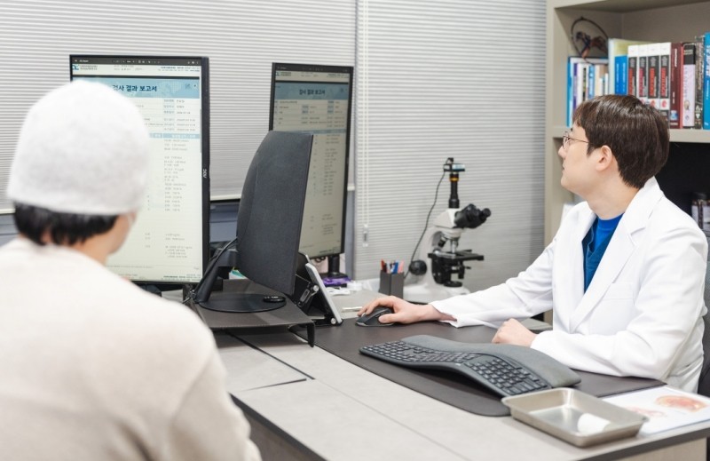 Urologist reviewing information on screen with a patient
