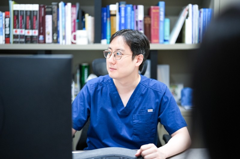 Urologist reviewing information on a computer in the consultation room