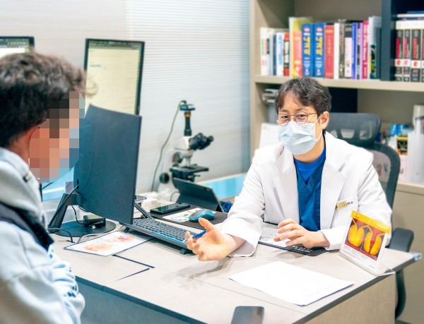 Urologist consulting with a patient across the desk