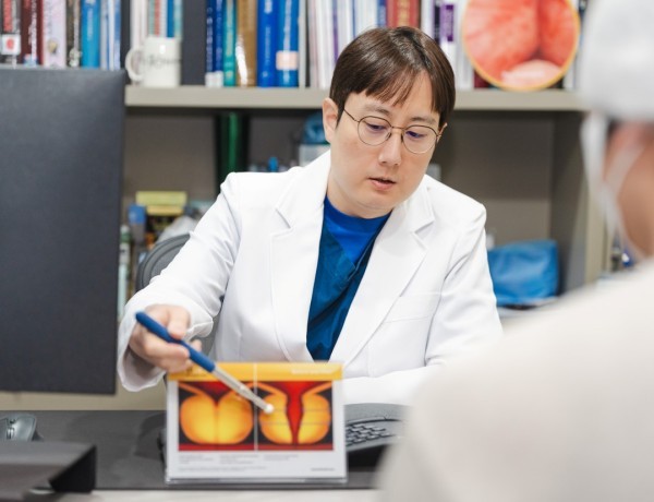Urologist pointing to the prostate on an anatomical diagram