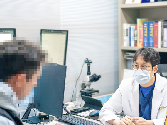 Urologist consulting with a patient across the desk